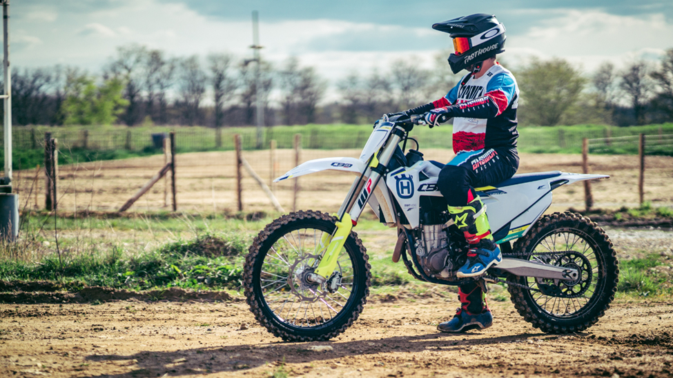 A man riding a dirt bike on a dirt road