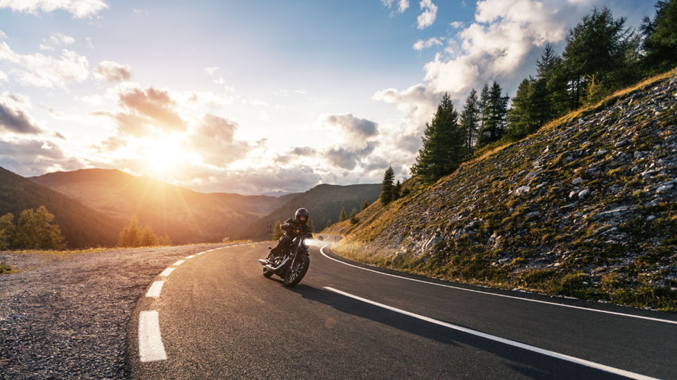 A man riding a motorcycle on a mountain highway